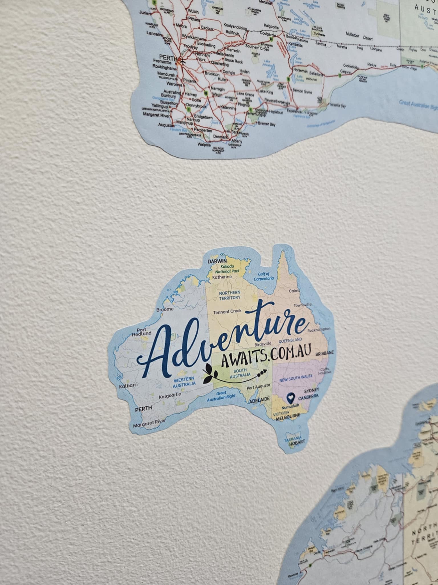 Map of Australia with 'Adventure Awaits.com.au' text on a textured surface