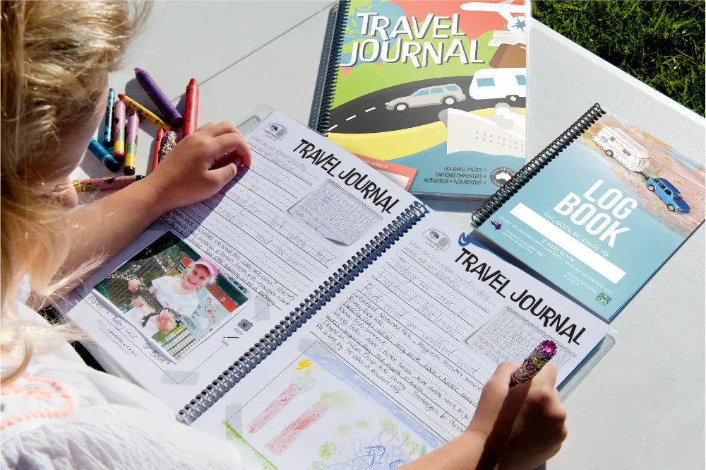 Young girl filling in an Adventure Awaits Kids Travel Journal outdoors with crayons — family road trip activity — Adventure Awaits