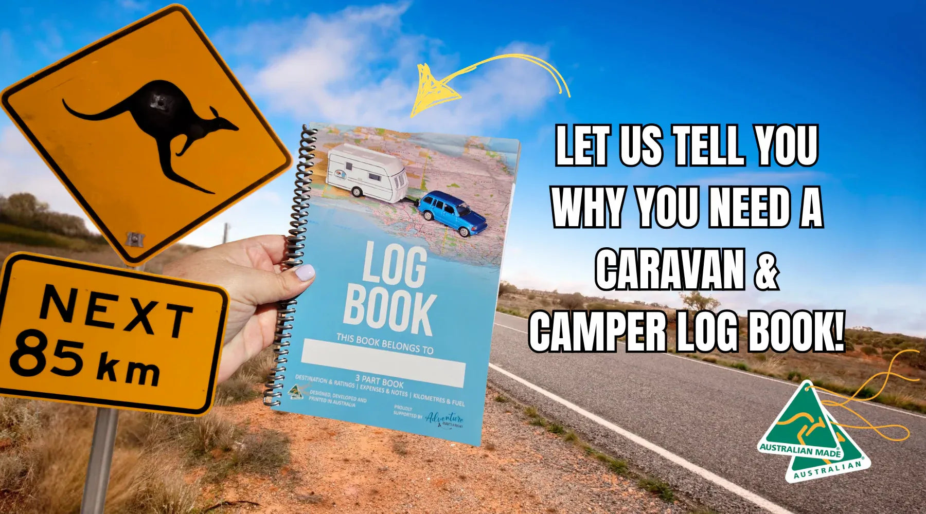 Adventure Awaits Caravan and Camper Log Book held beside an outback kangaroo sign — Australian made — Adventure Awaits