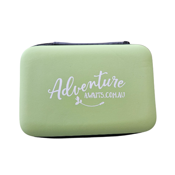 Green playing card case with 'Adventure Awaits' text on a white background