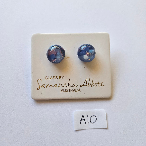 Pair of blue earrings on a glassblowing branded card with a white background