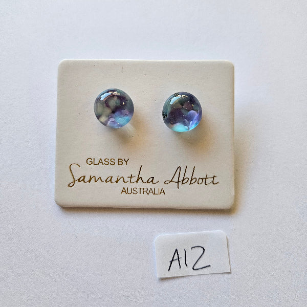 Pair of stud earrings on a glass by Samantha Abbott Australia card with a white background.