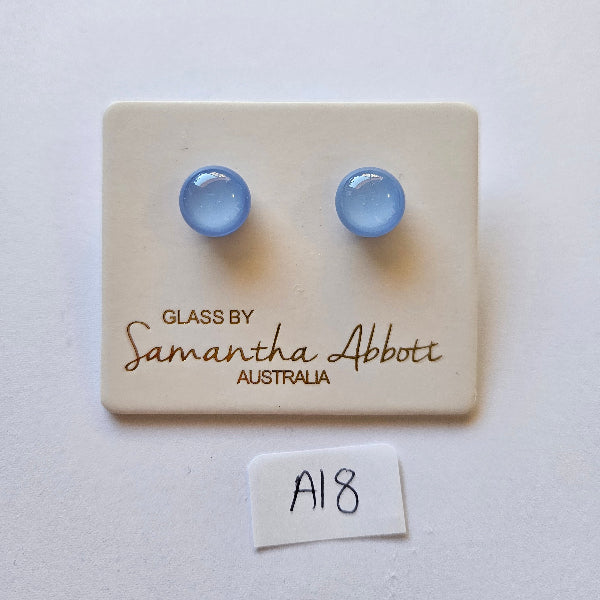 Pair of blue glass earrings on a branded card with 'Samantha Abbott' on a white background.