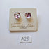 Pair of stud earrings on a Samantha Abbott branded card with a small label 'A25' to the side.