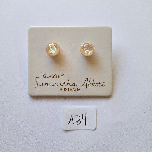 samantha abbott glass stud earrings Pair of pearl earrings on a branded card with a white background