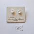 Pair of pearl earrings on a branded card with 'Samantha Abbott' branding.