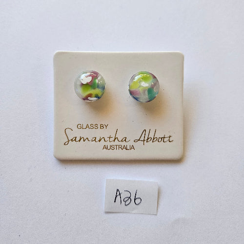 Pair of colorful glass earrings on a branded card with a white background