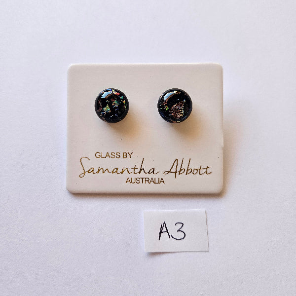 Pair of black earrings on a branded card with 'Samantha Abbott' on a white background