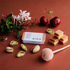 AIKU tin of solid perfume in Pistachio Affair with cherry, pistachio, caramel and floral fragrance notes — Adventure Awaits