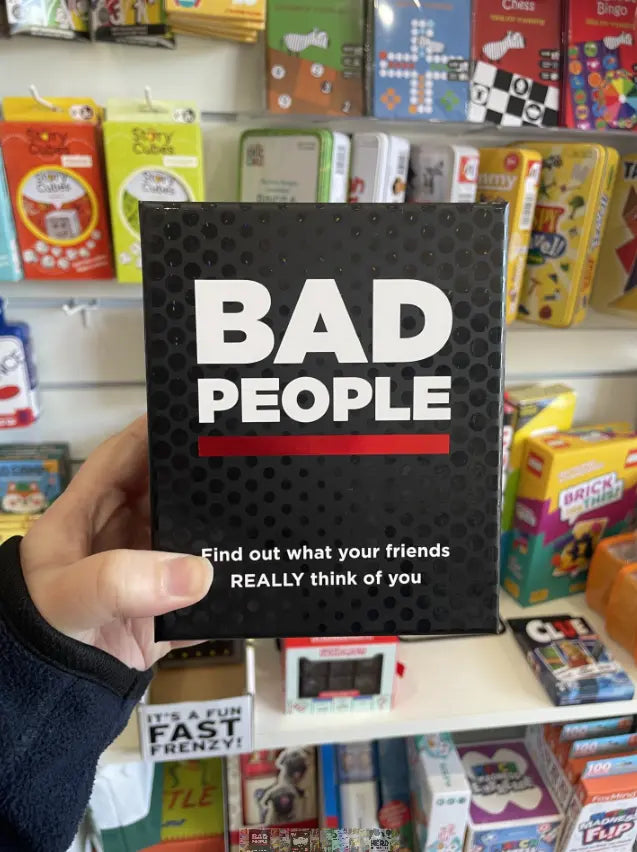 Bad People party game box held in store, black pack for adults game night Adventure Awaits