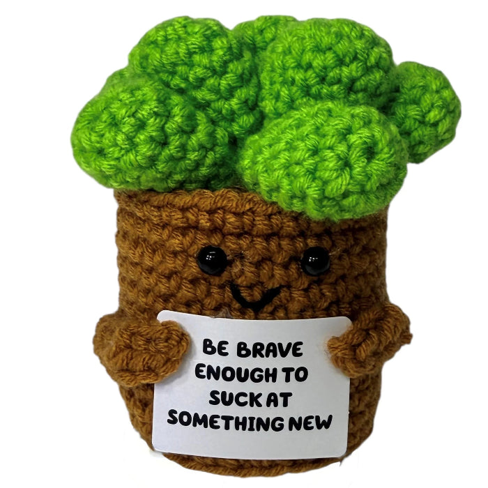 handmade crochet broccoli plush toy in a pot holding a funny motivational sign about trying something new