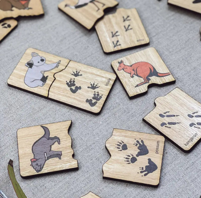 Australian animal track timber puzzle pieces with koala, kangaroo and possum footprints — Adventure Awaits