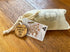 Australian alphabet timber discs packed in a cotton drawstring bag with product tag — Adventure Awaits