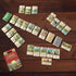 CATAN On the Road card game laid out for play with colourful resource and development cards, Adventure Awaits
