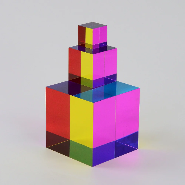 CMY Cubes stacked from large to small with vivid transparent red, yellow, pink and blue panels, Adventure Awaits