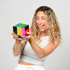 Woman smiling while holding Mega CMY Cube with vivid transparent colour panels, Adventure Awaits