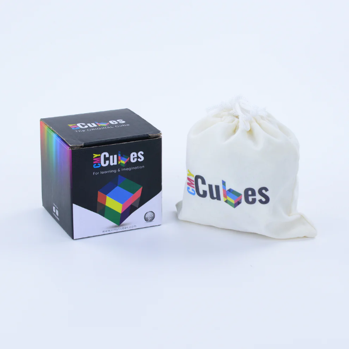 CMY Cubes gift box beside a white drawstring storage bag on a white background, Adventure Awaits