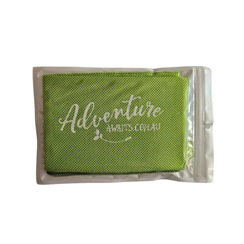 Green Adventure Awaits cooling towel in reusable packaging, lightweight mesh fabric for outdoor adventures and summer activities.