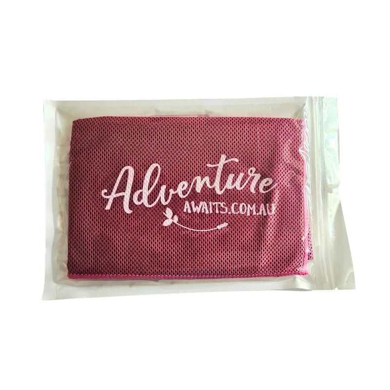 Pink Adventure Awaits cooling towel in reusable packaging, lightweight breathable fabric for keeping cool on hot days.