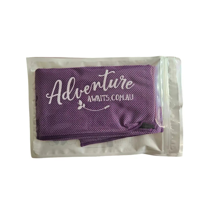 Purple Adventure Awaits cooling towel in reusable packaging, lightweight breathable fabric for travel, camping and hot weather.