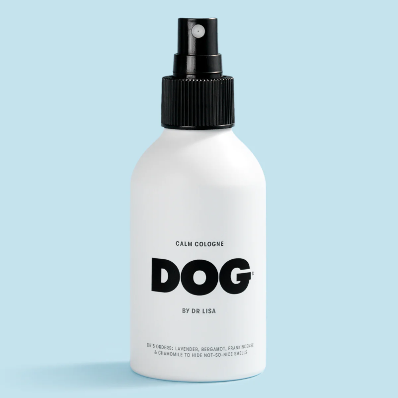 White spray bottle labeled 'DOG' on a light blue background