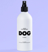 White spray bottle labeled 'Leave In Conditioner Spray DOG by De Lura' on a purple background