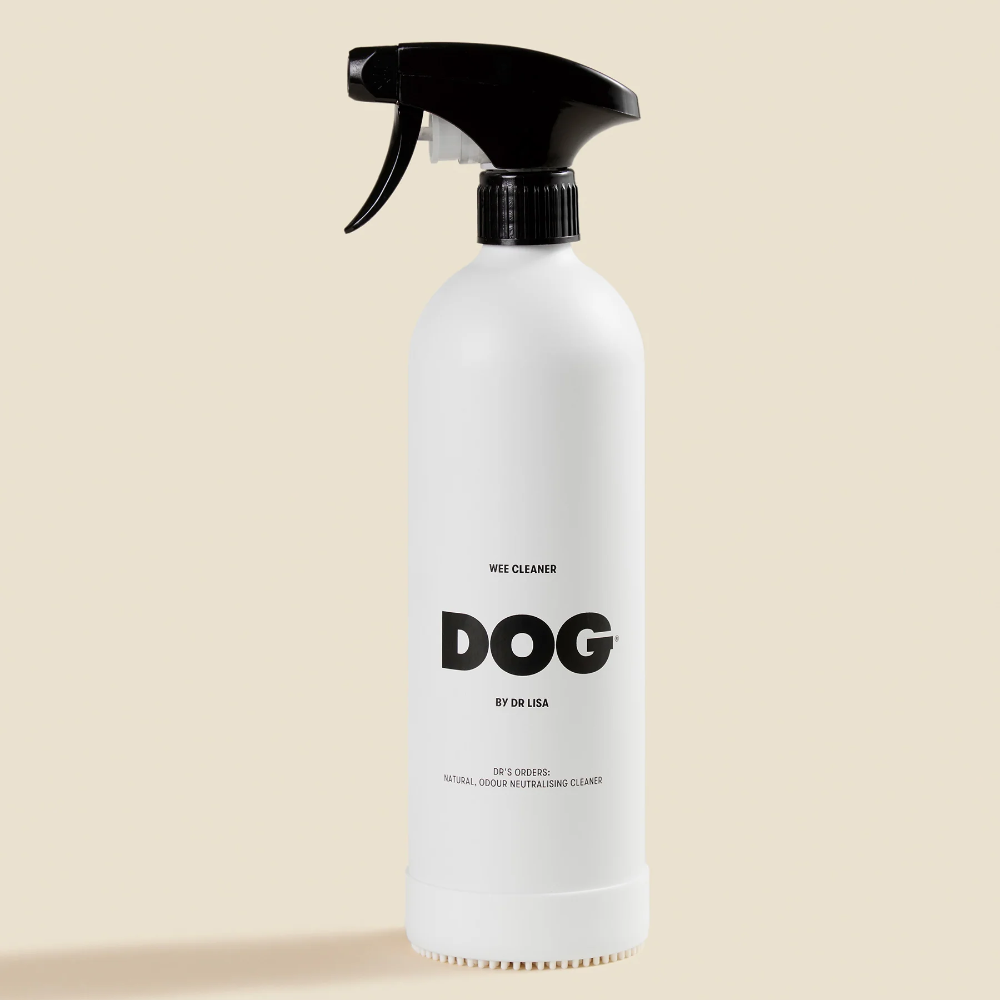 White spray bottle labeled 'DOG' on a beige background
