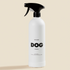 White spray bottle labeled 'DOG' on a beige background
