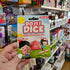 Hand holding a 'Do it! Dice' game packaging in a store aisle with various games.