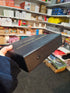 Hand holding the black Gamesource Double Fifteen domino storage case, showing its slim side profile — Adventure Awaits