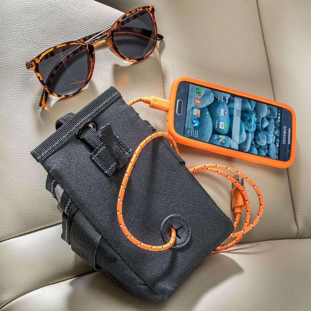 black car organiser pouch with charging cord, smartphone and sunglasses displayed on a car seat