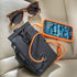 black car organiser pouch with charging cord, smartphone and sunglasses displayed on a car seat