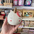 A white unicorn money box in a hand
