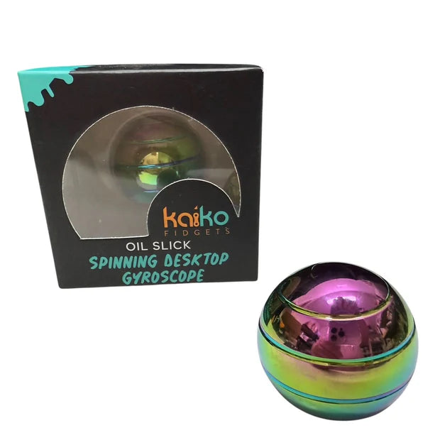 Oil slick gyroscope fidget shown beside packaging on white background
