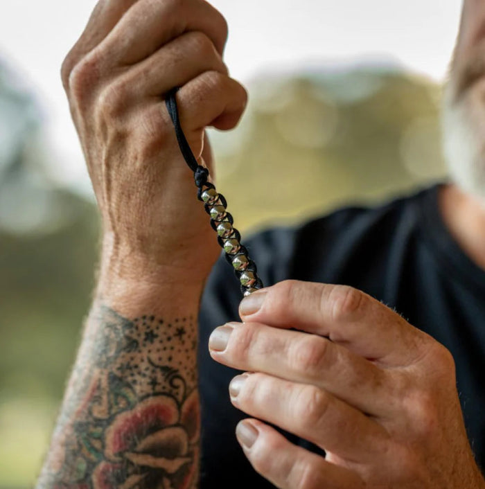 black hand caterpillar being held in hands by older man