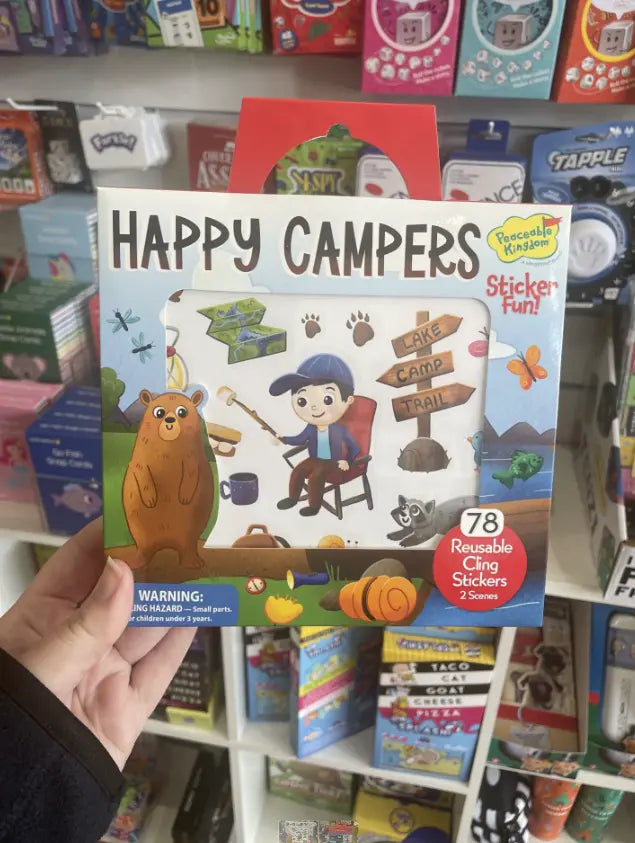 Happy Campers reusable cling sticker book held in store with camping stickers — Adventure Awaits