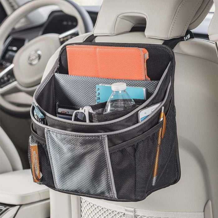 driverstash car organiser on back of beige leather car seat for back seat passengers use