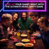 Friends laugh around a table while playing the Hitster music party game — Adventure Awaits