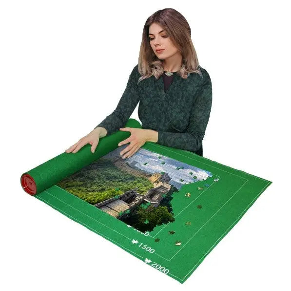 woman rolling up unfinished jigsaw puzzle on green puzzle mat, portable storage solution for safely storing puzzles in progress Adventure Awaits