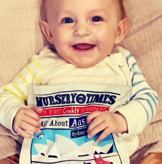 A child with Jo and Nics Crinkly Cloth Baby Books.
