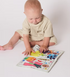 A child playing with 
Jo and Nics Crinkly Cloth Baby Books.