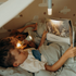 Adventure Awaits children reading under blankets with glowing Kidywolf portable LED night lights