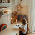Adventure Awaits child reading at a desk with glowing Kidywolf portable LED night lights in a cosy playroom