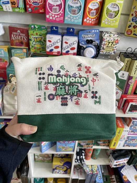 Travel Mahjong game pouch held in store with white and green zip bag — Adventure Awaits