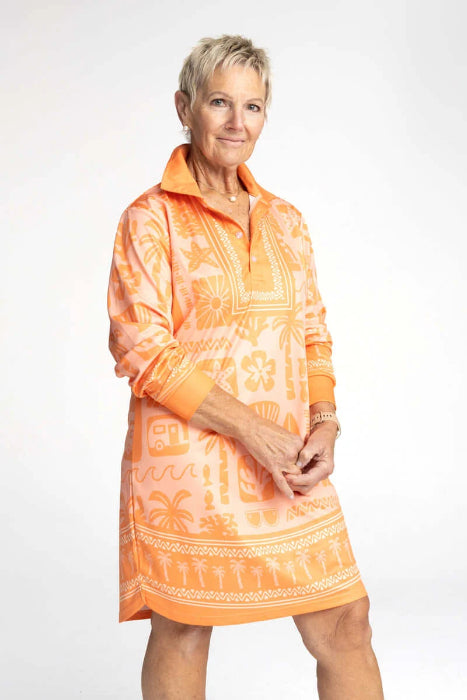 Woman wearing an orange patterned long-sleeve shirt dress with collar and beach-inspired print — Adventure Awaits