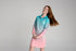 Girl smiling and tossing her hair in an aqua and pink long-sleeve UPF50+ fishing dress — Adventure Awaits