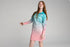Girl posing in an aqua and pink long-sleeve UPF50+ fishing dress against a plain backdrop — Adventure Awaits