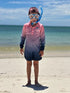 Child wearing a pink and navy long-sleeve swim top with snorkel mask while standing on a beach — Adventure Awaits