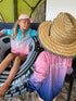 Two girls relaxing at a campsite in aqua, pink and navy long-sleeve fishing shirts and sun hats — Adventure Awaits