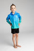 Boy posing in a blue and aqua long-sleeve fishing shirt with black shorts — Adventure Awaits
